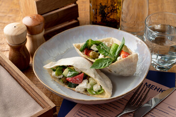 Mediterranean greek pita pocket with salad and feta cheese inside, appetizing commercial photo