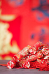 Firecracker ornaments in front of blurred red background