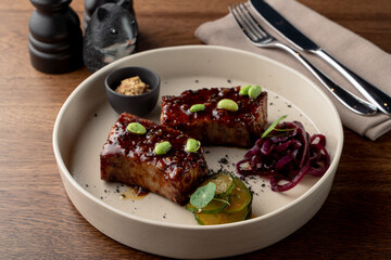Tofu steak, marinated in teriyaki sauce and served with edamame beans, gourmet meal in a fancy restaurant, top view