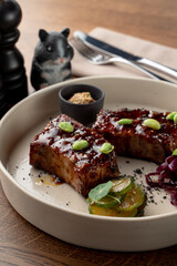 Teriyaki sauce crab cakes, glazed and spicy with edamame beans, close up on wooden background in soft light, fancy restaurant photo