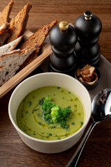 Side view of  hot autumn cream pea soup with bread basket and spoon aside, warm and cozy photo