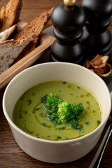Close up green cream soup with olive oil swirls on it, soft light, autumn cozymeal