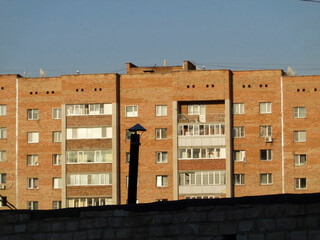 Apartment building. Ust-Kamenogorsk (Kazakhstan). Blue sky. Multistorey building. Residential area. Architectural background. Evening