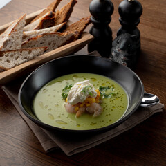 Seafood cream soup with crab meat and prawns in a fancy fish restaurant, soft light, appetizing food commercial, wooden background