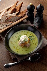 Top view of seafood cream soup with prawns in a fancy fish restaurant, appetizing food commercial, bread and spoon aside