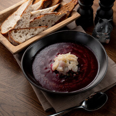 Cold russian beetroot soup with scallop in a russian fancy restaurant, top view on wooden table