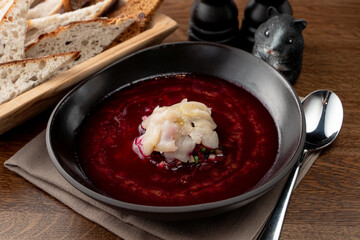 Fine dining russian restaurant: cold borscht in a black designer bowl, modern russian cuisine