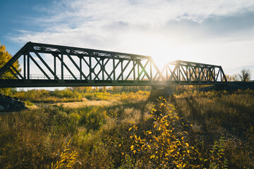 Maintenance Trains Crossing Truss Bridge in Autumn