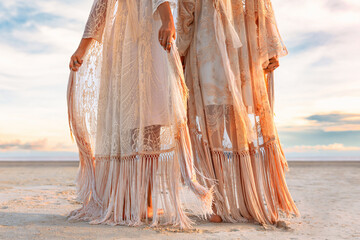 two beautiful young woman in elegant boho dresses oudoors at sunset © zolotareva_elina