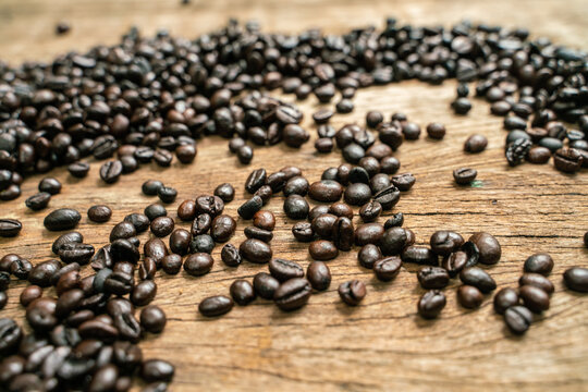 Coffee beans on old rusty brown wood background © themorningglory