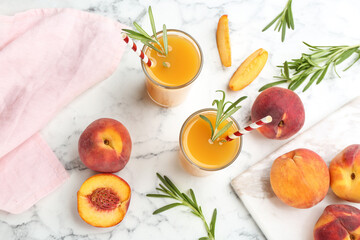 Natural peach juice and fresh fruits on white marble table, flat lay