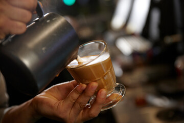 hand holding a cup of coffee