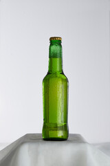 Wet green beer bottle with drops of water