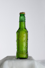 Wet green beer bottle with ice frost