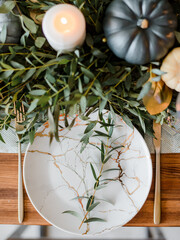 Autumn table setting with pumpkins.