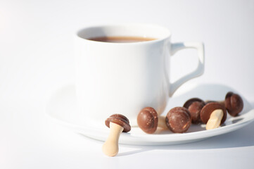 white cup of coffee with chocolate cookie