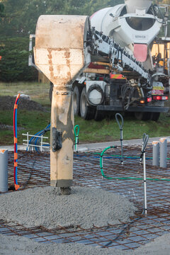 mixer truck pouring concrete on the construction site