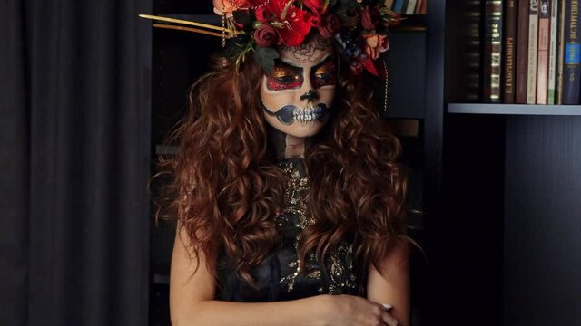 Portrait of beauty young woman dressed as catrina, skull to honor the dead in Mexico.