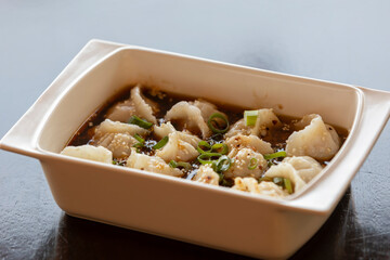 Chinese spicy dumplings in a bowl