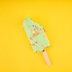 Ice  cream Green tea stick with almonds on yellow background