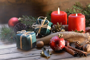 traditional christmas decoration on wooden background with candles and gifts - Powered by Adobe