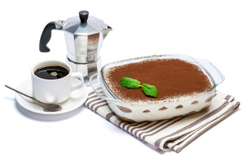 Traditional Italian Tiramisu dessert in glass baking dish, coffee maker and cup of fresh espresso isolated on white background with clipping path