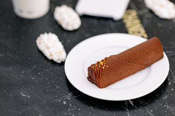 chocolate desserts on the background of a black table with coffee to go