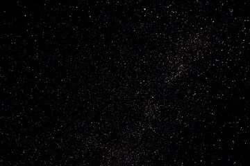 Stars on a dark night sky. Blurred, defocus. Abstract background