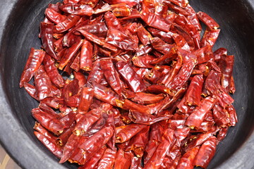 Dry hot red chillies on Black background from top view.