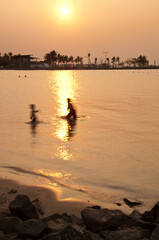 Two people are playing on the beach