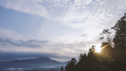 Beautiful sky in the morning with sunrise and misty mountain