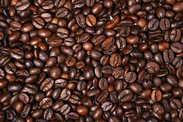 Dark roast coffee beans background, top view