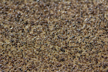 Full frame macro abstract background view of sand paper texture with stone grit