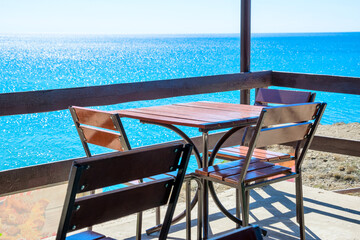 Table and chairs by the sea