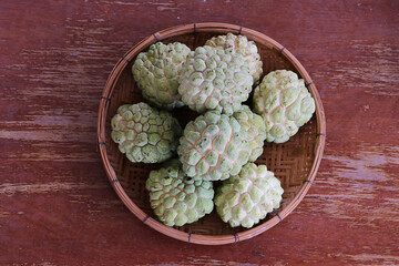 View a group of custard apple in basket, tropical fruits from Asia