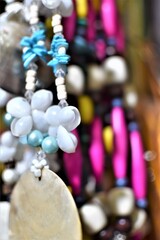 Bead necklace adorned with seashells and capiz shells or windowpane oyster