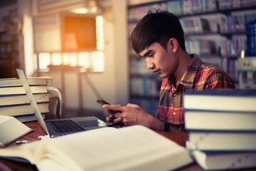 The young man is studying for knowledge in the library