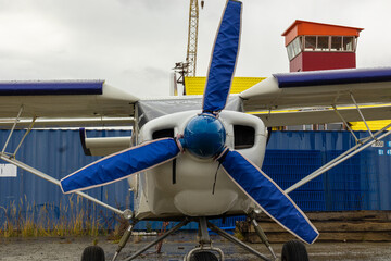 old small civil aircraft parked at the airport in the rain in autumn