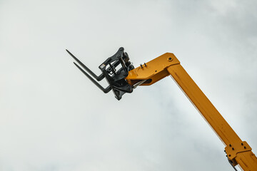 Forklift industrial loader or stacker against sky.