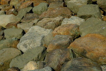 Background from a stone of igneous rock. Wallpaper made of textures of boulders of volcanic origin....