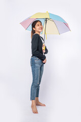 A woman wearing a black shirt and standing with an umbrella