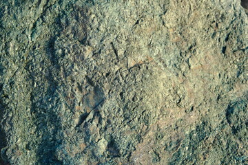 Background from a stone of igneous rock. Wallpaper made of textures of boulders of volcanic origin....
