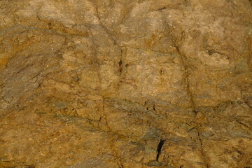 Background from a stone of igneous rock. Wallpaper made of textures of boulders of volcanic origin....
