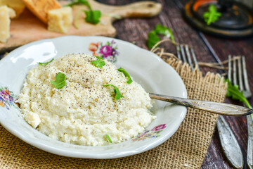 Italian creamy  cheese risotto with parmesan cheese and fresh basil on rustic background
