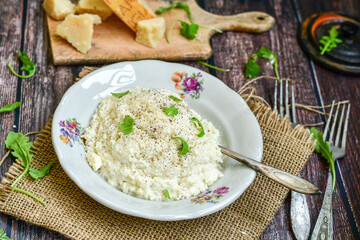 Italian creamy  cheese risotto with parmesan cheese and fresh basil on rustic background