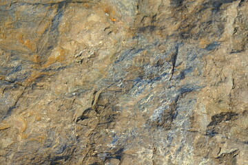 Background from a stone of igneous rock. Wallpaper made of textures of boulders of volcanic origin....