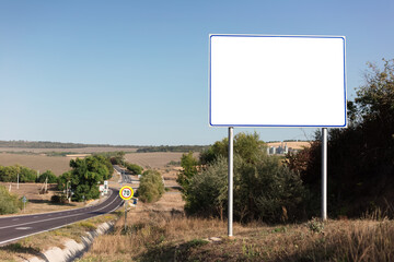 Empty billboard for advertising poster near asphalting road. Background of blue sky and beautiful nature.