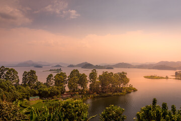 Lake Mutanda at sunset with view on the volcanoes mount Muhavuru and mount Gahinga in East Africa,...