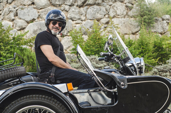 Mature with sunglasses man on sidecar looking at camera