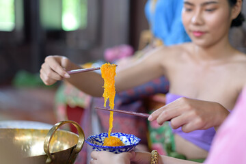 Fototapeta na wymiar Thai people make Thai dessert in Thai period costume